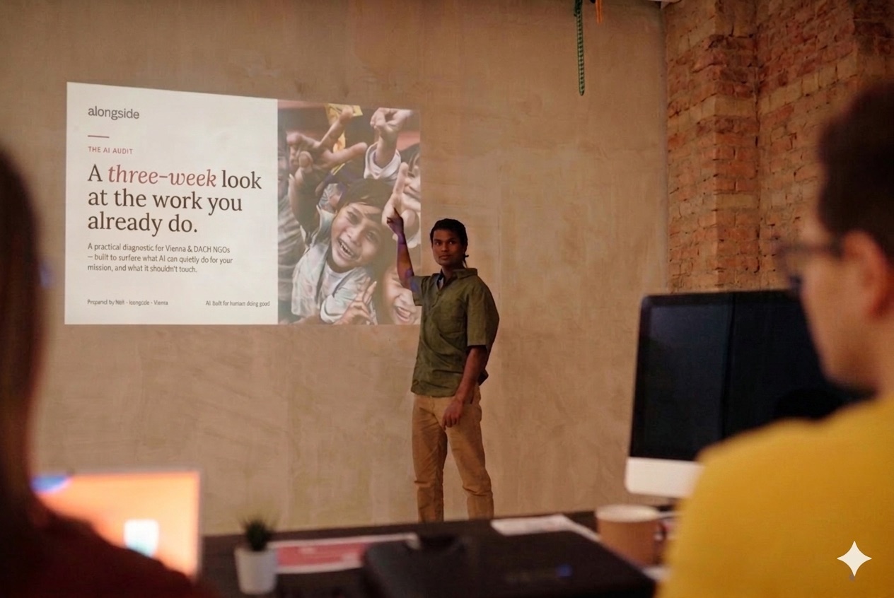 An alongside workshop: Neil presenting the AI audit to a small team in a brick-walled community room